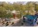 Aerial view of the community playground and picnic area surrounded by mature trees and landscaping at 320 N 168Th Dr, Goodyear, AZ 85338