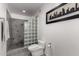 Bathroom featuring glass block shower, gray tile and monochromatic skyline art at 3655 N 5Th Ave # 213, Phoenix, AZ 85013