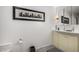 Clean and contemporary bathroom with a double sink vanity and modern fixtures, plus a large framed wall art at 3655 N 5Th Ave # 213, Phoenix, AZ 85013