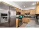 Well-equipped kitchen showcases stainless steel appliances, including refrigerator, oven, microwave and granite countertops with ample wood cabinetry at 3655 N 5Th Ave # 213, Phoenix, AZ 85013