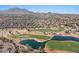 Scenic aerial view of the community, golf course, and mountain backdrop at 3746 E Vallejo Dr, Gilbert, AZ 85298