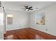 Bedroom with hardwood floors, ceiling fan, and windows providing natural light at 3746 E Vallejo Dr, Gilbert, AZ 85298