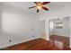 Bedroom featuring hardwood flooring, mirrored closet doors, and a ceiling fan at 3746 E Vallejo Dr, Gilbert, AZ 85298