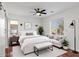 Stylish bedroom with natural light, features a comfortable bed, ceiling fan and cozy sitting area at 3746 E Vallejo Dr, Gilbert, AZ 85298