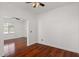 Bedroom with hardwood floors, ceiling fan, and natural light from the window at 3746 E Vallejo Dr, Gilbert, AZ 85298