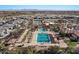 Aerial view showcasing a pristine community pool with covered lounge areas and palm trees at 3746 E Vallejo Dr, Gilbert, AZ 85298