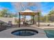 Poolside gazebo area with a dining set, overlooks a relaxing spa, ideal for outdoor lounging at 3746 E Vallejo Dr, Gilbert, AZ 85298