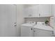 Modern laundry room features white cabinetry, plus front load washer and dryer for convenience at 3746 E Vallejo Dr, Gilbert, AZ 85298