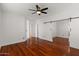 Spacious main bedroom with wood floors, ceiling fan, and sliding door closet at 3746 E Vallejo Dr, Gilbert, AZ 85298