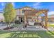 Serene backyard featuring a charming porch swing under a pergola, perfect for relaxing and enjoying the outdoors at 3906 N 297Th Cir, Buckeye, AZ 85396