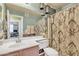 Bathroom with decorative light fixtures above the vanity mirror and patterned shower curtain at 3906 N 297Th Cir, Buckeye, AZ 85396