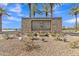 Beautiful stone entrance sign of the Tartesso community with manicured landscaping and flowering plants at 3906 N 297Th Cir, Buckeye, AZ 85396