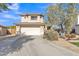 Charming two-story home featuring a well-manicured lawn and an attached two-car garage at 3906 N 297Th Cir, Buckeye, AZ 85396