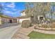 Two-story home boasts a stone fire pit, a cozy pergola swing, and lush green grass at 3906 N 297Th Cir, Buckeye, AZ 85396