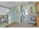 Upstairs hallway with neutral carpet and pale green walls, with a guitar hanging on the wall at 3906 N 297Th Cir, Buckeye, AZ 85396