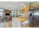 Open-concept kitchen featuring an island, stainless steel appliances, and abundant cabinet space at 3906 N 297Th Cir, Buckeye, AZ 85396