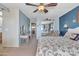 Comfortable main bedroom featuring a ceiling fan, and a walk-in closet with mirrored doors at 3906 N 297Th Cir, Buckeye, AZ 85396