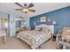 Cozy main bedroom showcasing a ceiling fan, and a walk-in closet with mirrored doors at 3906 N 297Th Cir, Buckeye, AZ 85396