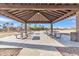 Covered picnic area with multiple tables and benches for outdoor dining and relaxation at 3906 N 297Th Cir, Buckeye, AZ 85396