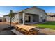 Backyard featuring rock landscaping, artificial turf, and a covered patio at 3923 S 244Th Dr, Buckeye, AZ 85326