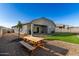 Backyard with rock landscaping, artificial turf, and a picnic table at 3923 S 244Th Dr, Buckeye, AZ 85326