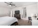 Another view of the spacious primary bedroom featuring a ceiling fan, carpet, and neutral colors at 3923 S 244Th Dr, Buckeye, AZ 85326