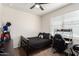 Bedroom with dark furniture, carpet, ceiling fan, and natural light from a window at 3923 S 244Th Dr, Buckeye, AZ 85326