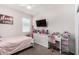 Bedroom with soft pink accents, a white dresser, and a desk at 3923 S 244Th Dr, Buckeye, AZ 85326