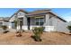 Inviting home featuring a cozy front porch with seating, complemented by desert landscaping at 3923 S 244Th Dr, Buckeye, AZ 85326