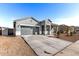 Well-maintained home with desert landscaping, a two-car garage, and covered front porch at 3923 S 244Th Dr, Buckeye, AZ 85326