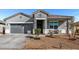 Attractive single-Gathering home with a gray exterior, covered porch, and low-maintenance landscaping at 3923 S 244Th Dr, Buckeye, AZ 85326