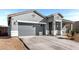 Attractive single-story house with a two-car garage, covered entry, and desert landscaping at 3923 S 244Th Dr, Buckeye, AZ 85326