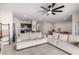 Open-concept living room and kitchen with tile flooring and modern ceiling fan at 3923 S 244Th Dr, Buckeye, AZ 85326