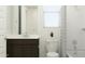 Well-lit bathroom with a shower-tub combo, a dark vanity, and modern white tiling at 4583 E French Rd, San Tan Valley, AZ 85143