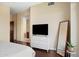 Relaxing bedroom features a white dresser, a modern mirror, and wood floors at 4931 N Woodmere Fairway -- # 1001, Scottsdale, AZ 85251