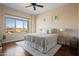 Calm bedroom with large window, neutral decor, hardwood floors, and natural light at 4931 N Woodmere Fairway -- # 1001, Scottsdale, AZ 85251