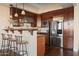 Charming kitchen featuring stainless steel appliances, breakfast bar, and dark wood cabinetry at 4931 N Woodmere Fairway -- # 1001, Scottsdale, AZ 85251