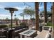 Inviting outdoor seating area with comfortable couches, fire pit, and lush landscaping at 4931 N Woodmere Fairway -- # 1001, Scottsdale, AZ 85251