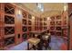 Elegant wine cellar featuring wooden storage cabinets, a tasting table, and ambient lighting at 4931 N Woodmere Fairway -- # 1001, Scottsdale, AZ 85251