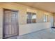 Apartment's front entrance featuring a secure metal screen door and a large window for natural light at 537 S Delaware Dr # 115, Apache Junction, AZ 85120