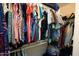 Well-organized walk-in closet filled with colorful clothing and various bags at 537 S Delaware Dr # 115, Apache Junction, AZ 85120