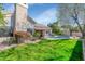 Inviting backyard with a pool, lush green grass, and colorful flowers at 5507 E Shea Blvd, Scottsdale, AZ 85254