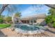 Resort-style backyard with a beautiful pool, stone patio, and comfortable lounge seating at 5507 E Shea Blvd, Scottsdale, AZ 85254