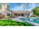 Inviting backyard featuring a sparkling pool, patio seating, and lush landscaping at 5507 E Shea Blvd, Scottsdale, AZ 85254