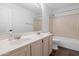 Clean bathroom with a double sink vanity, a large mirror, and a shower-tub combination at 5507 E Shea Blvd, Scottsdale, AZ 85254