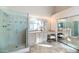 Bathroom with a glass-enclosed shower, lighted mirrors, and vanity with dual seating at 5507 E Shea Blvd, Scottsdale, AZ 85254