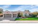 Charming single-story home featuring a three-car garage and lush landscaping at 5507 E Shea Blvd, Scottsdale, AZ 85254