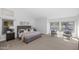 Spacious main bedroom with neutral colors, large windows, and comfortable seating area overlooking the pool at 5507 E Shea Blvd, Scottsdale, AZ 85254