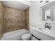 A well-lit bathroom with a shower-tub combo, modern vanity, and stylish tile work, ensuring a refreshing experience at 5919 W Villa St, Phoenix, AZ 85043