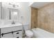 Bathroom featuring a shower-tub combo, modern vanity, and tile work, perfect for relaxation at 5919 W Villa St, Phoenix, AZ 85043